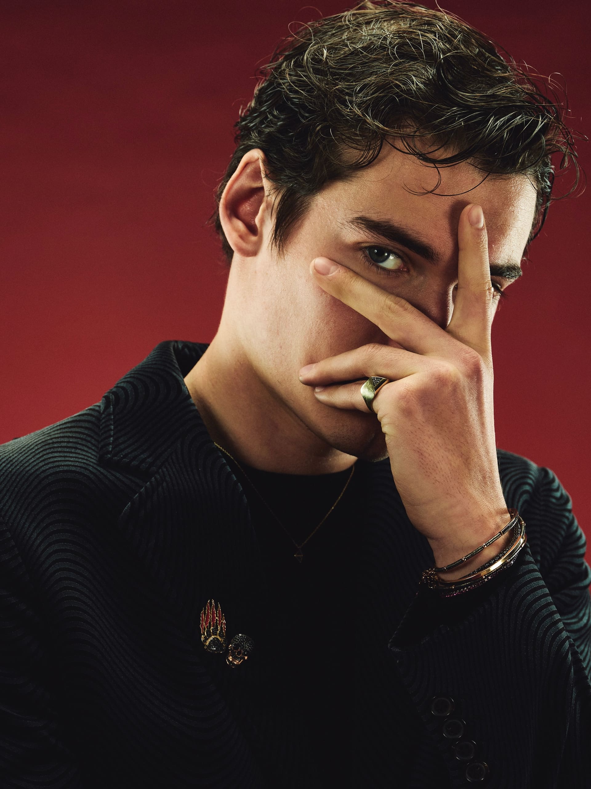 Fingers spread across the face with a gold signet ring on show in Dime Tribe's red-room portraits.
