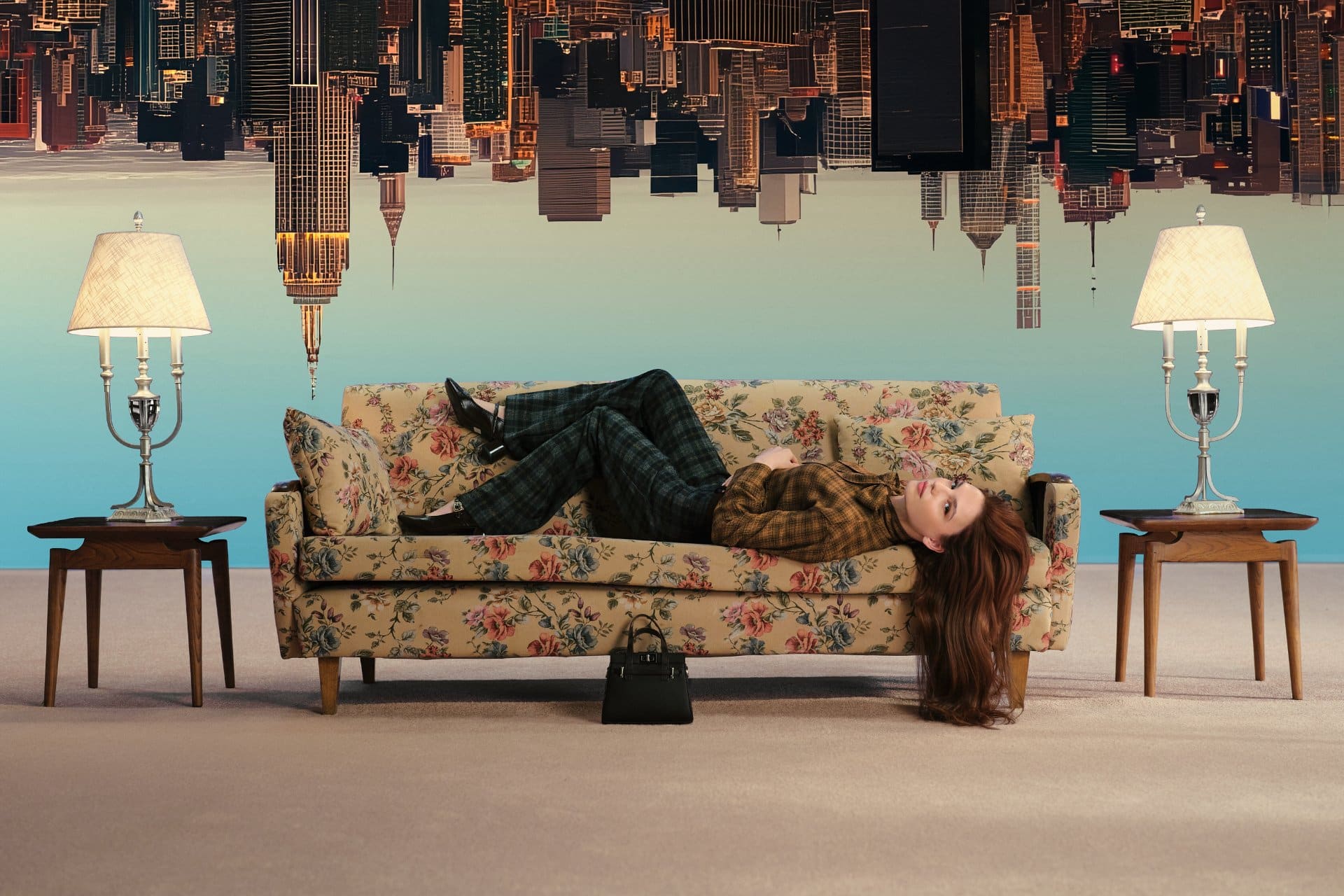 Nilsu Berfin Aktaş stretches across a floral sofa as the Manhattan skyline hangs upside down overhead for LC Waikiki.