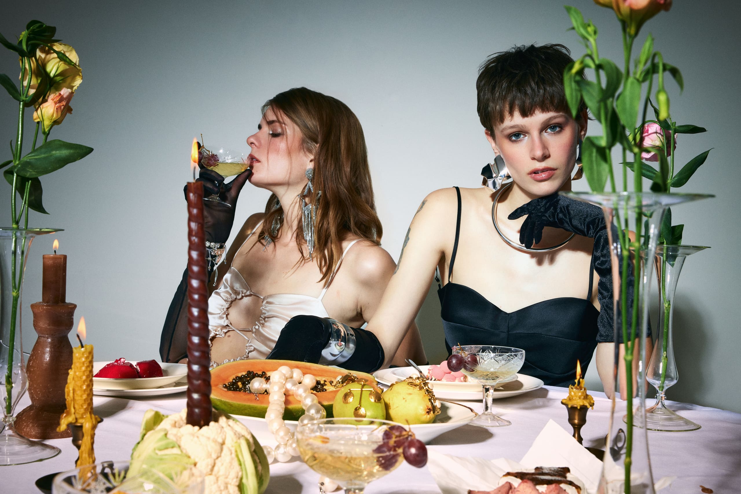 Champagne sipped in profile and a velvet-gloved stare as the Mers Silk dinner party slides into decadence.