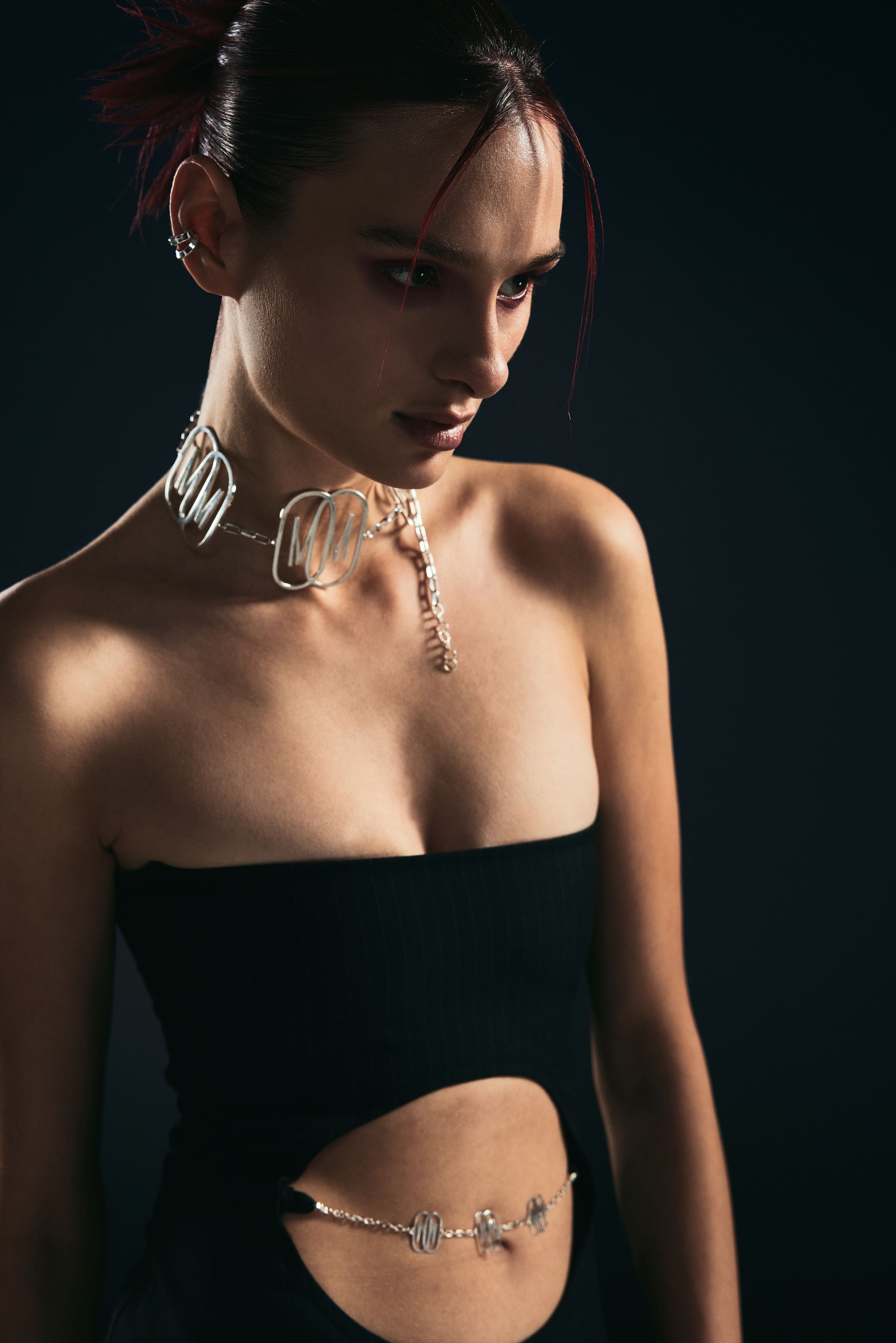 Mysamoon's logo choker and belly chain gleam against bare skin in the campaign's tightest beauty frame.