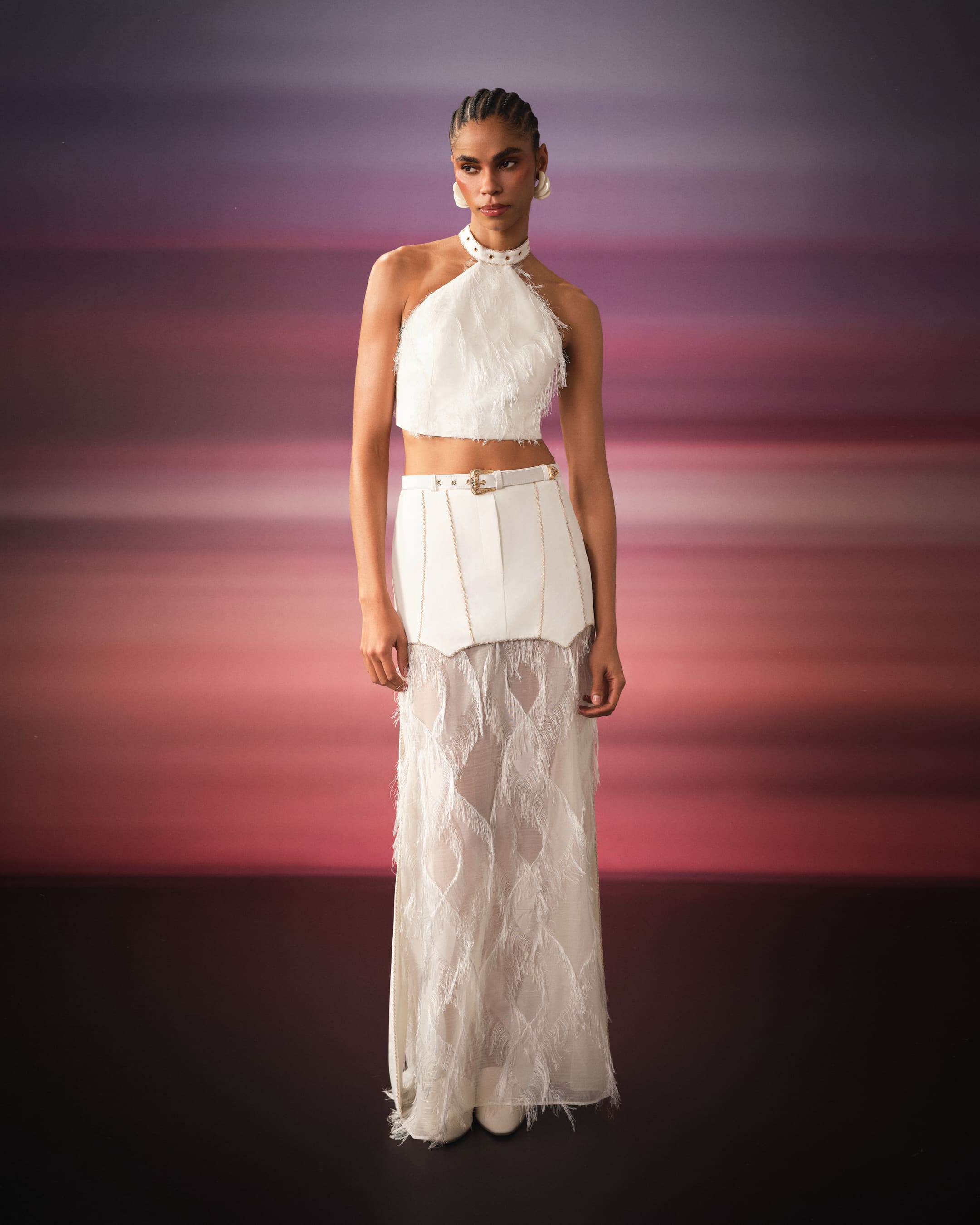 A white halter fringe set with a western belt against banded sunset colour for Saint Ones.