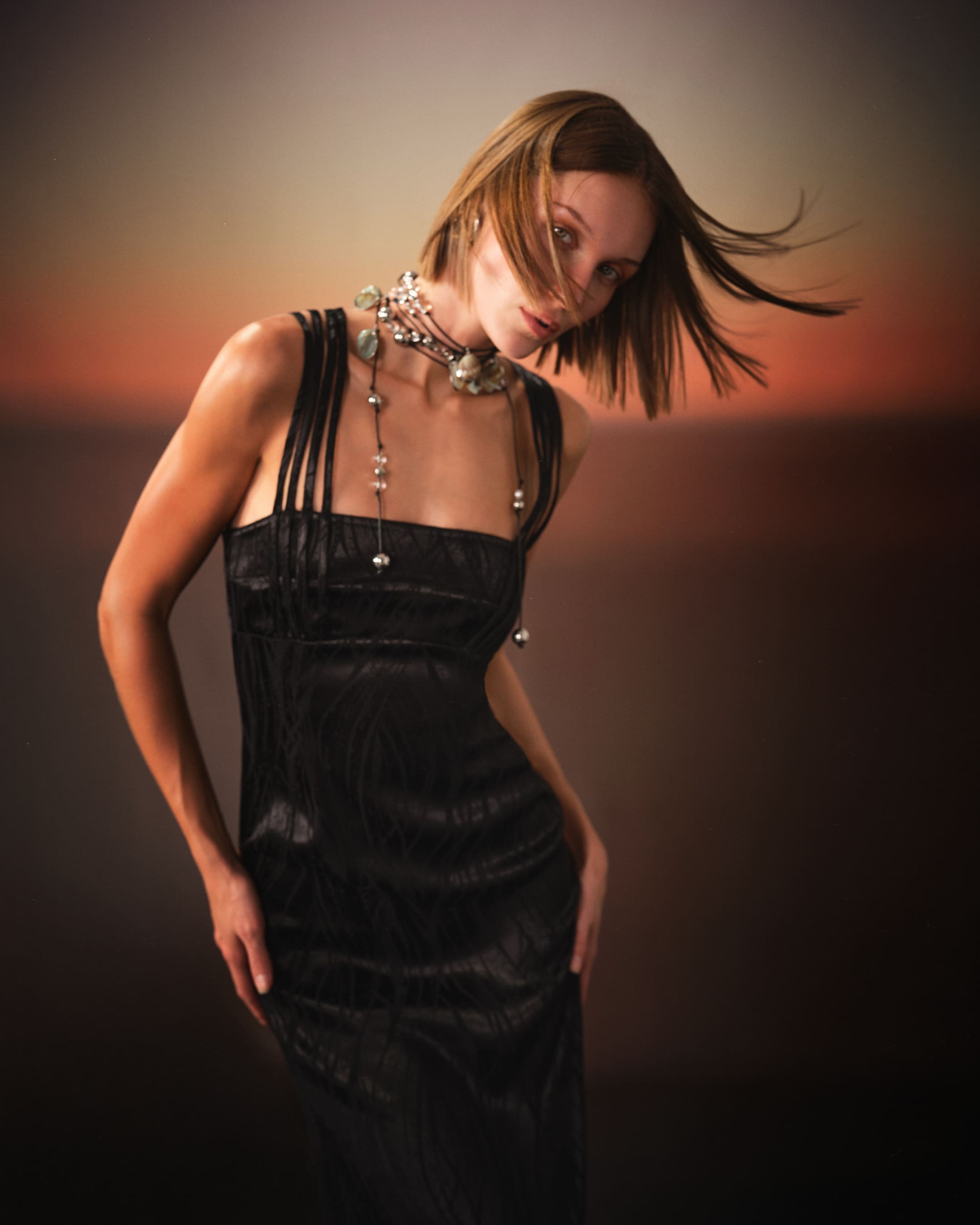 Hair mid-flight over the satin gown, closing Saint Ones' Cosmic Rebirth in motion.