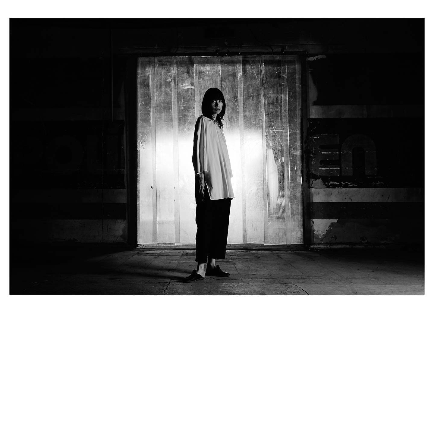 A lone figure backlit by a glowing freight door in an abandoned depot closes ST Studio's Unborn campaign.